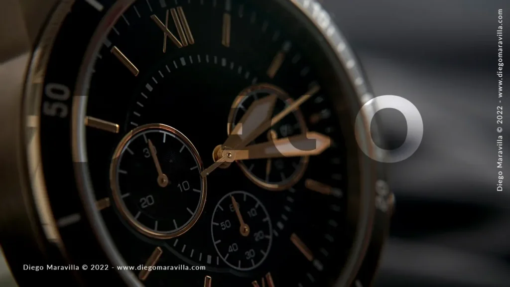 Black and gold wristwatch. Take a close up photo
