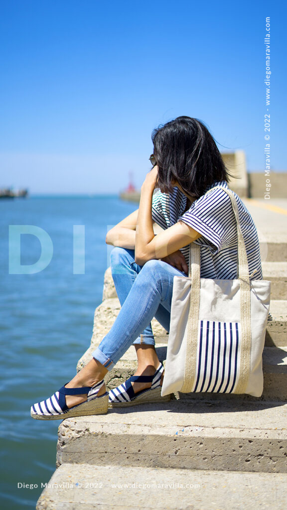 Girl on vacation at the beach with a summer marine style outfit