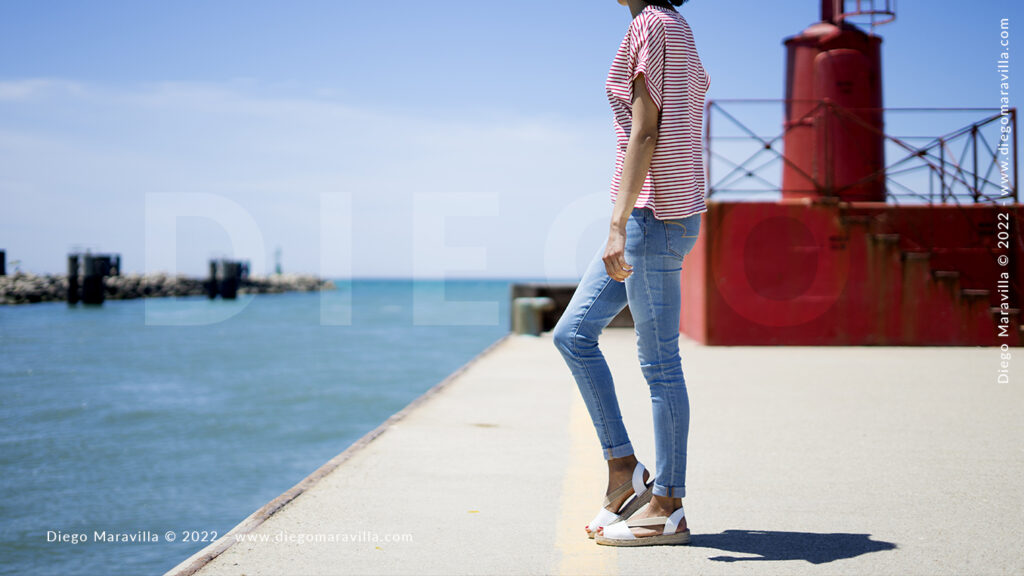 Girl on vacation walking in Italian port in summer time