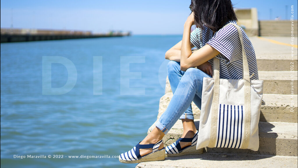 Summer style on the beach and girl watching the panorama